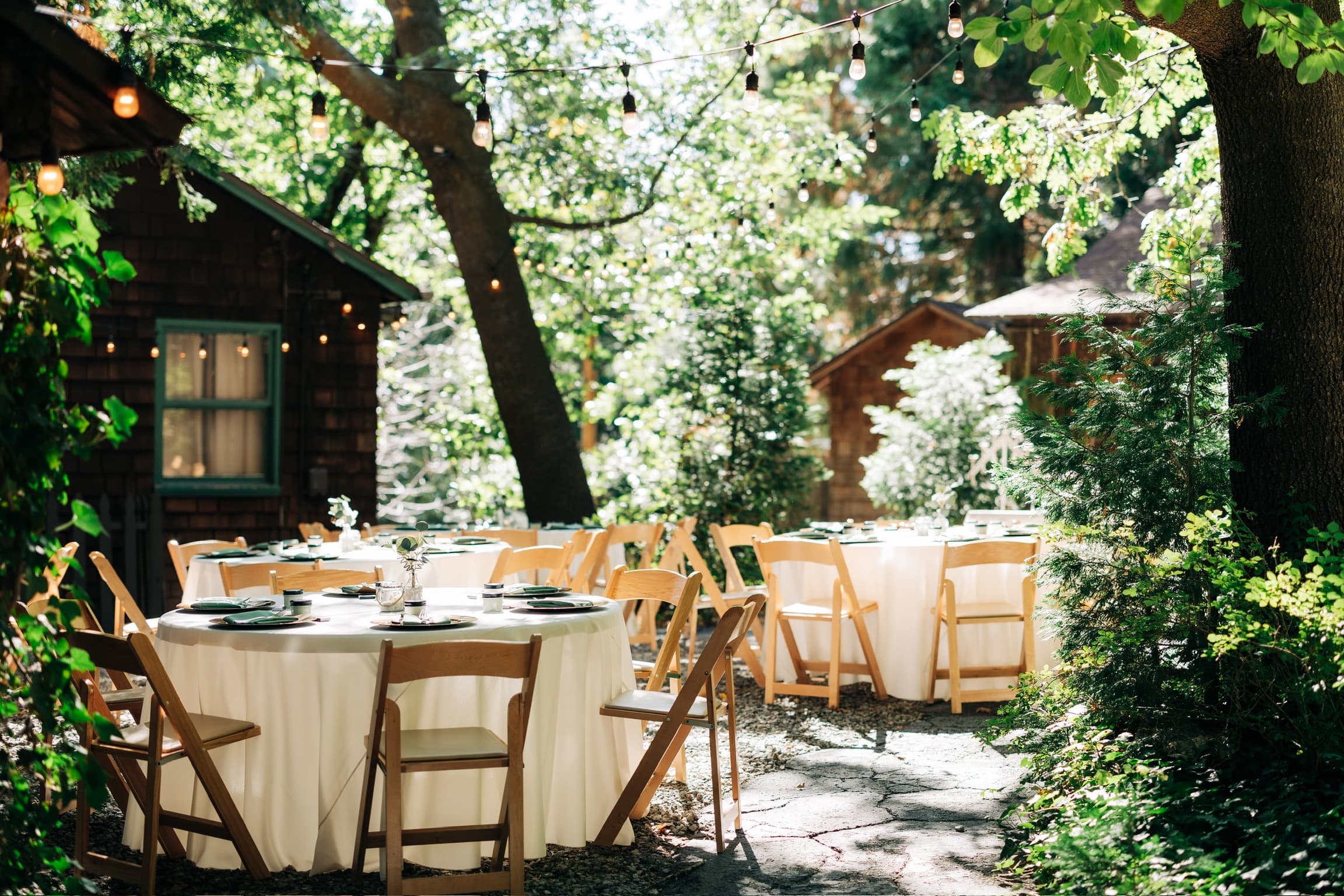 Tables set for a celebration among the pines and cabins at Willow Woods Park today