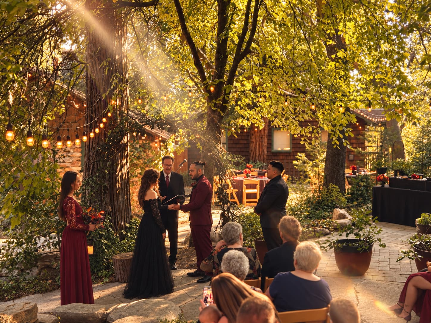 Late afternoon sunlight falling through the pines onto a wedding ceremony at Willow Woods Park